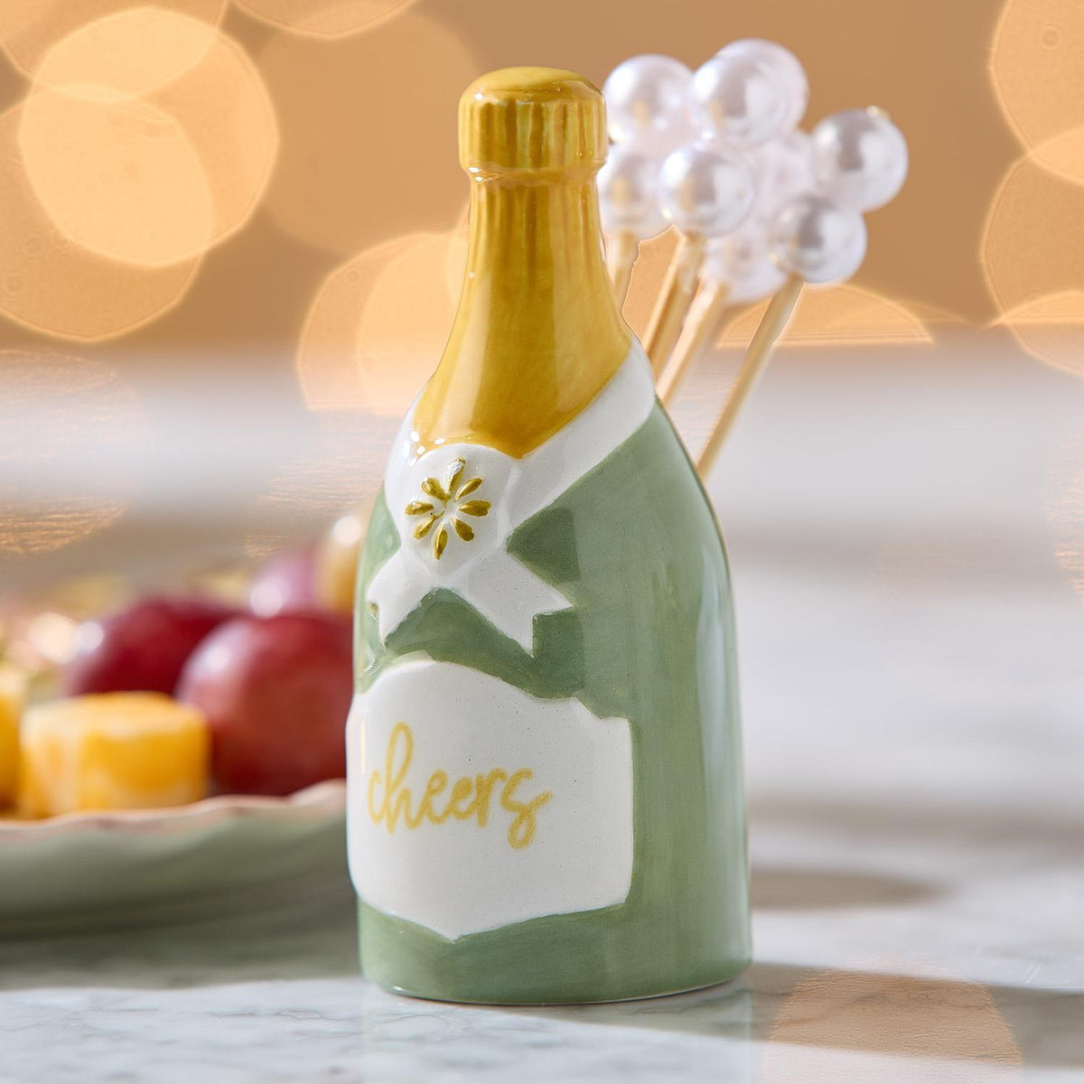 Champagne bottle pick holder with pearl cocktail picks on a party table