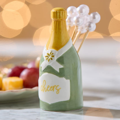Champagne bottle pick holder with pearl cocktail picks on a party table