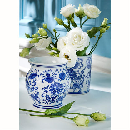 Chinoiserie vases with white roses on a windowsill