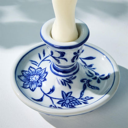 Close-up of chinoiserie candleholder holding a white taper candle