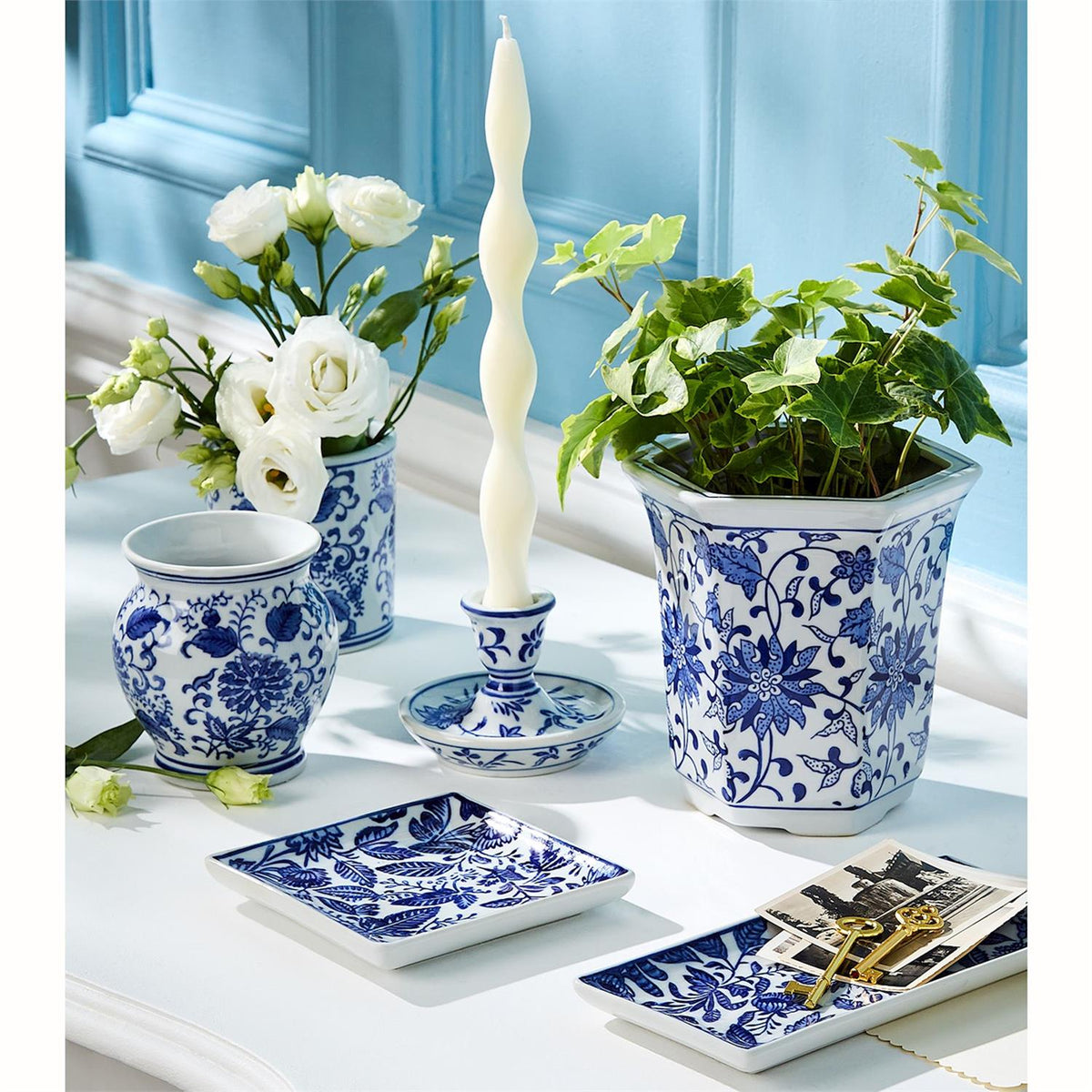 Chinoiserie trays styled with blue and white vases and candleholders
