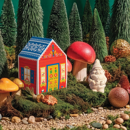 The Gnome's Cottage Soap styled in a mossy woodland scene with bottle brush trees, mushrooms and the gnome soap beside the cottage