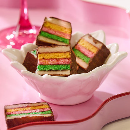 White poinsettia tidbit dish filled with rainbow cookies