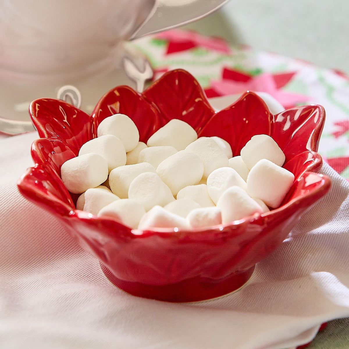 Poinsettia flower-shaped candy dish on a holiday table