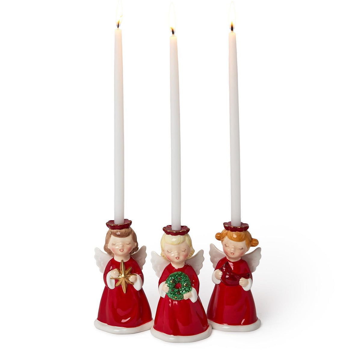 Three angel candleholders with white taper candles