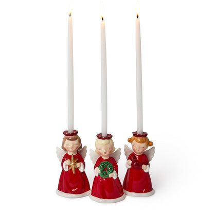 Three angel candleholders with white taper candles