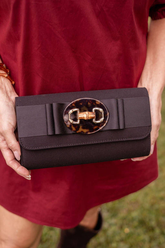 Lisi Lerch Avery black clutch with flat bow and tortoise bamboo toggle