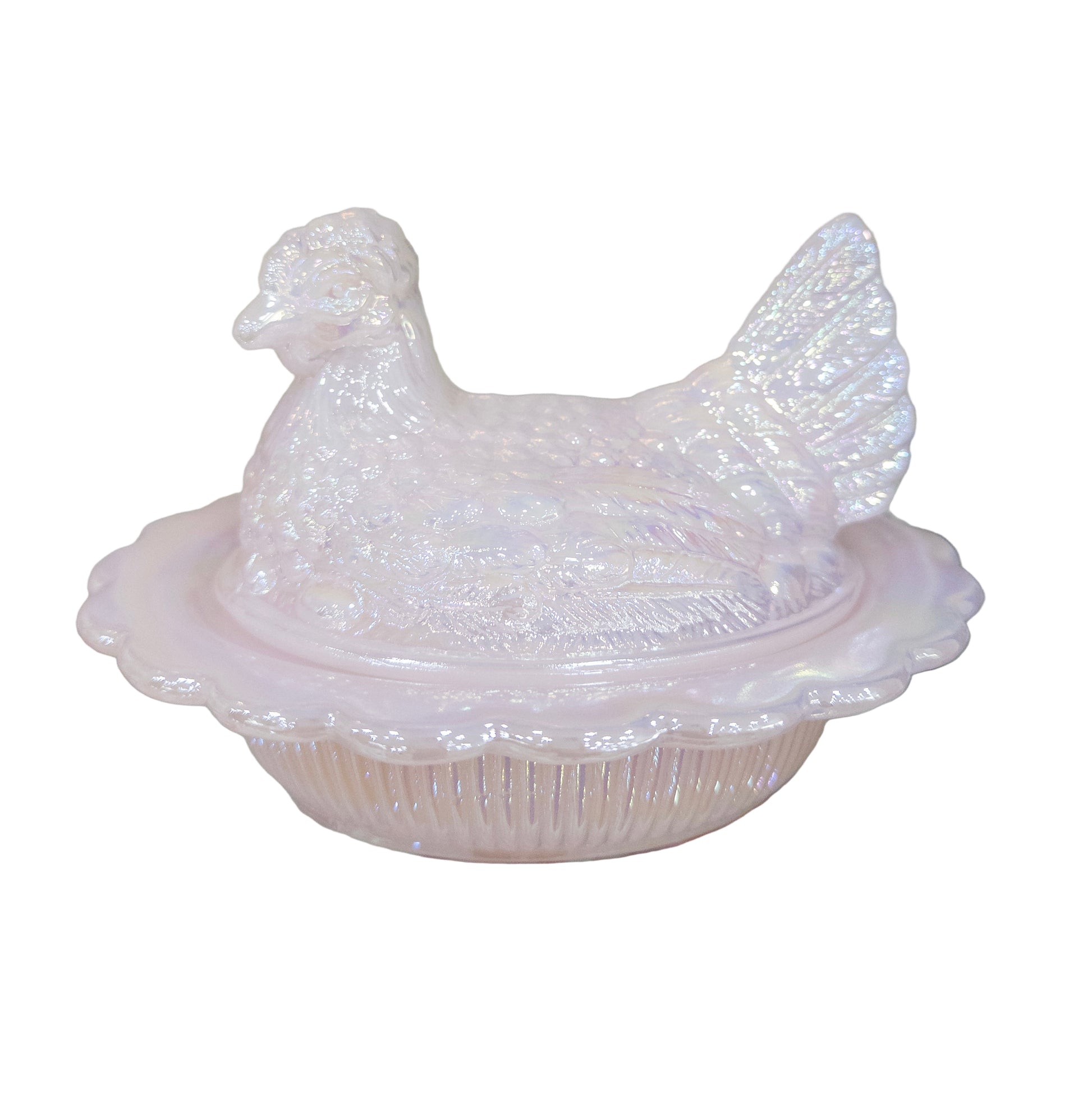 Decorative pink ceramic chicken with a lid on a glass surface
