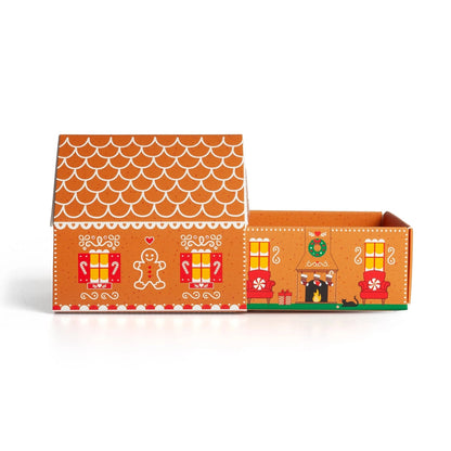 Gingerbread matchbox cottage with the drawer fully removed, showing the fireplace and wreath printed inside