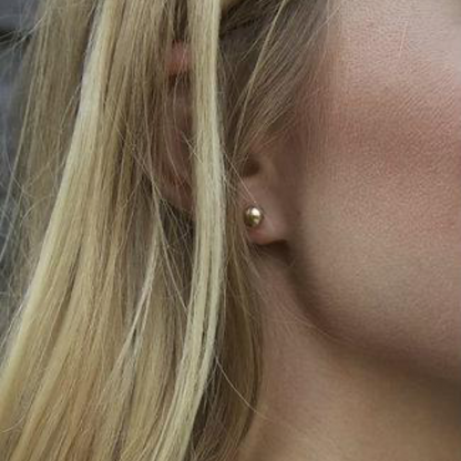 enewton Classic 6mm Ball Stud Earrings in Gold worn in an ear