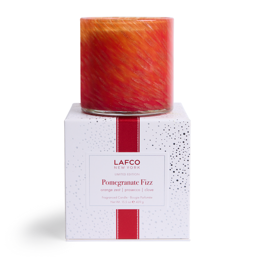 LAFCO Pomegranate Fizz Signature Candle 15.5 oz - red and orange hand-blown glass vessel on its white LAFCO gift box