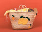 Woven basket with fruit patterns on a red background