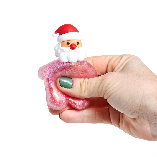 Hand squeezing a pink glitter Santa squishy toy